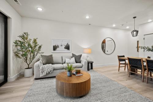 a living room with a couch and a table at Alpine Retreat at the Pointe Pt A106 in Eden