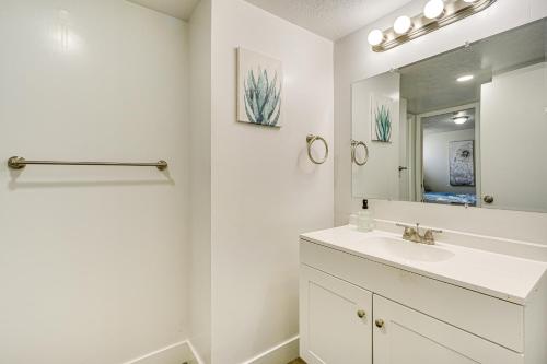 a white bathroom with a sink and a mirror at 3 Mi to Valley Fair Mall Salt Lake City Apt! in West Valley City