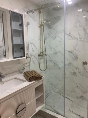 a bathroom with a shower and a sink at Water-front and swimingpool apartment in Aourir