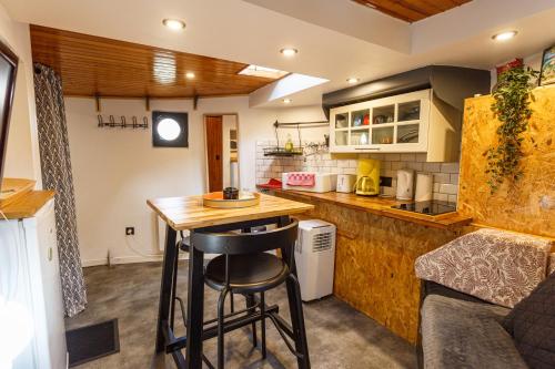 a kitchen with a counter and a bar in a room at Péniche de charme avec jacuzzi sur canal du midi in Toulouse