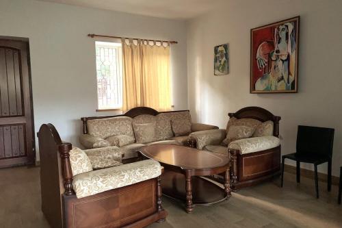 a living room with a couch and a table at Panoramic Gallery House in Garni