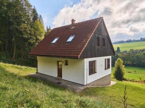 a small house with a brown roof on a hill at Holiday Home Stárkov by Interhome in Stárkov
