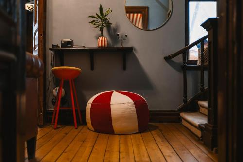 a room with a ottoman sitting on a wooden floor at Köpmans Boutique Hotel & Bistro in Höganäs