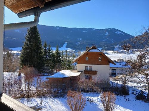 a view of a house in the snow at Pension & Apartments Weissbriach in Weissbriach