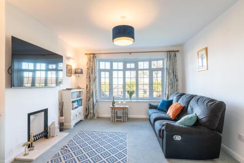 a living room with a couch and a window at Port View House 3-Bedroom Self Catering Family Home with Garden Near Cardiff in Cardiff
