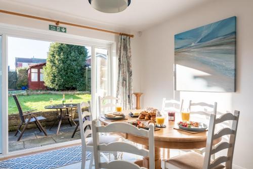 a dining room with a table and chairs and a sliding glass door at Port View House 3-Bedroom Self Catering Family Home with Garden Near Cardiff in Cardiff