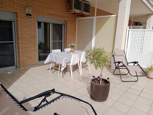a patio with a table and chairs on a house at Piso con piscina y parking in Peñíscola