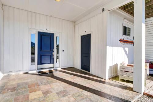 an empty house with blue doors and a patio at Ocean Air Entire by Sea Scape Properties in Surf City