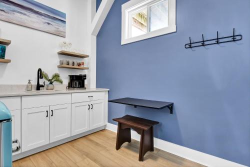 a kitchen with white cabinets and a table in it at Ocean Air Entire by Sea Scape Properties in Surf City