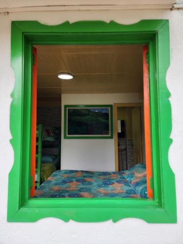 a mirror reflecting a bed in a room at Hotel Casa Quinta Salento in Salento