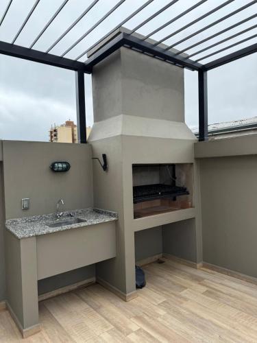 a bathroom with a sink and a large window at Apartamento Loftier Brete in Posadas