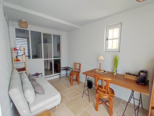 un salon avec un canapé et une table dans l'établissement Studio en centre ville d'Uzès, à Uzès