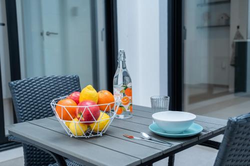 a bowl of fruit on a table with a bottle at Apartamento Molino y GARAJE in Ronda