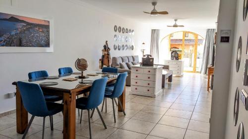 a dining room with a table and blue chairs at I love Marina Greenwich, Altea in Altea