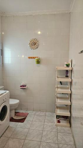 a bathroom with a toilet and a washing machine at Hurghada Village sea view in Hurghada