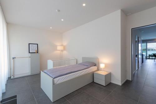 a bedroom with a bed and a table and a window at Residenza Du Lac in Paradiso