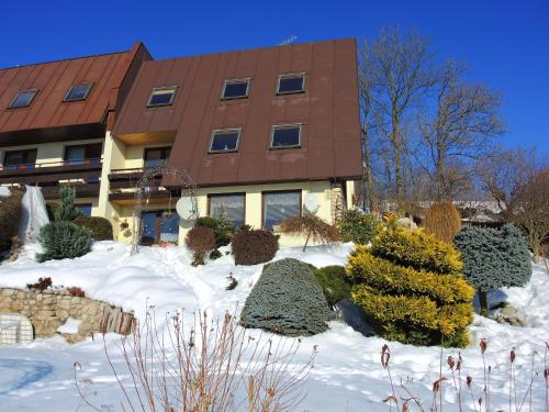 a building with snow in front of a building at Bella Vista in Vrchlabí