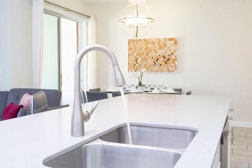 a kitchen with a sink and a counter top at 4BD/3BA Champions Gate Home With Private Pool in Davenport