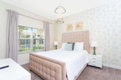 a bedroom with a large bed and a window at 4BD/3BA Champions Gate Home With Private Pool in Davenport