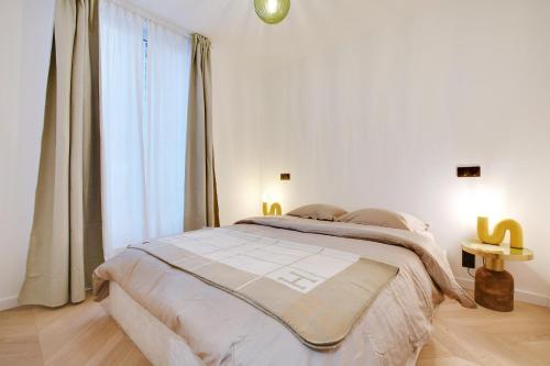 une chambre avec un grand lit et une grande fenêtre dans l'établissement Appartement de luxe à Boulogne, à Boulogne-Billancourt