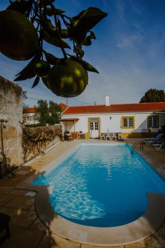 a villa with a swimming pool in front of a house at Aba da Serra - Turismo Rural in Abrigada