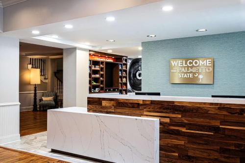 a hotel lobby with a reception counter and a wall of wood at Hampton Inn & Suites Charleston-West Ashley in Charleston