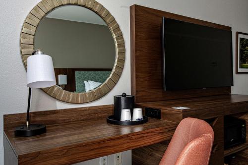 a living room with a television and a mirror at Hampton Inn & Suites Charleston-West Ashley in Charleston