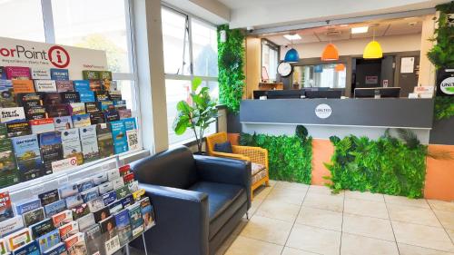 a store with a waiting room with a blue chair in it at United Auckland in Auckland