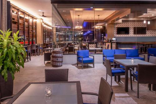 a restaurant with tables and chairs and a bar at Hilton Lexington Downtown in Lexington