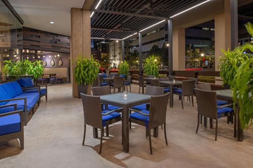 a restaurant with tables and chairs and plants at Hilton Lexington Downtown in Lexington