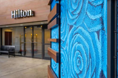 a building with a blue wall in front of a building at Hilton Lexington Downtown in Lexington