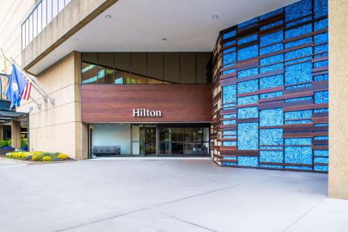 a building with a hilton sign on the side of it at Hilton Lexington Downtown in Lexington