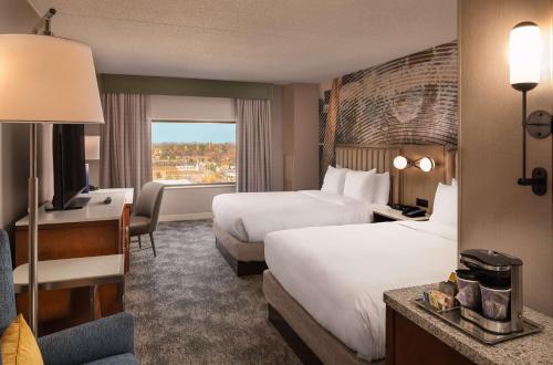 a hotel room with two beds and a window at Hilton Lexington Downtown in Lexington