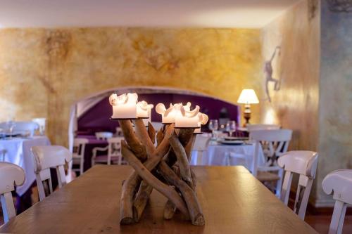 a table with some candles on top of it at Chateau des Ducs de Joueuse, BW Signature Collection in Couiza
