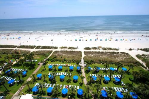 an aerial view of a beach with blue and white umbrellas at Boardwalk Beach Resort in Myrtle Beach