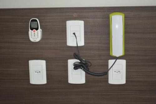 a group of electronic devices with a cell phone at Hamara Soft Hotel in Altamira