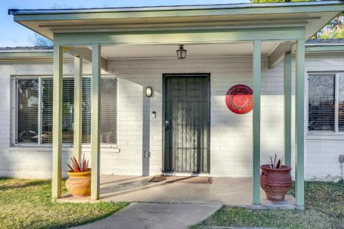 a front door of a white house with a gate at Pet-Friendly Phoenix Home Breezeway and Fenced Yard in Phoenix