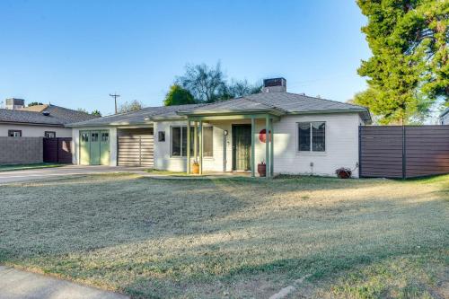 a white house with a garage at Pet-Friendly Phoenix Home Breezeway and Fenced Yard in Phoenix