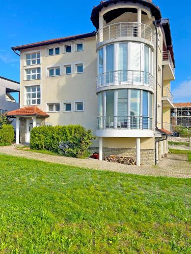a large apartment building with a round building at Qendresa Luxury Apartments in Prishtinë
