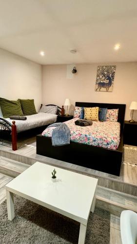 a living room with a bed and a coffee table at Cozy Home in London