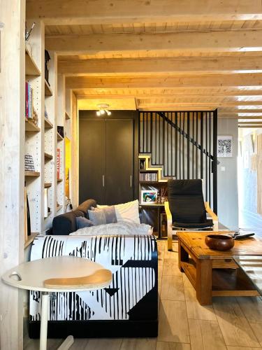 a living room with a bed and a table at Casa da Artista - Stylish House with Plunge Pool and Lush Garden close to Beach in Estômbar