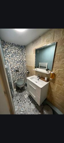 une salle de bain avec un lavabo et des toilettes dans l'établissement Joli studio centre-ville Caen, à Caen