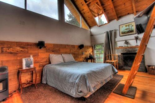 a bedroom with a large bed and a fireplace at Hotel Boutique Frutos del bosque by Rotamundos in Jicolapa