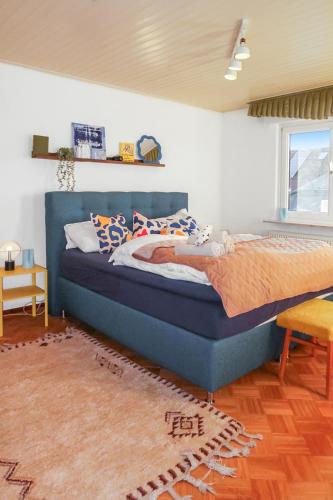 a bedroom with a blue bed in a room at Homestay - Panoramablick über Büdingen in Büdingen