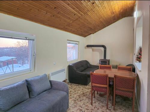 a living room with a couch and a table at Vila Nera in Železnička Stanica Karlovački Vinogradi