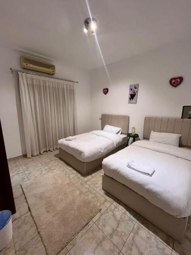 a bedroom with two beds in a room at Zamalek cozy central 2BR in Cairo