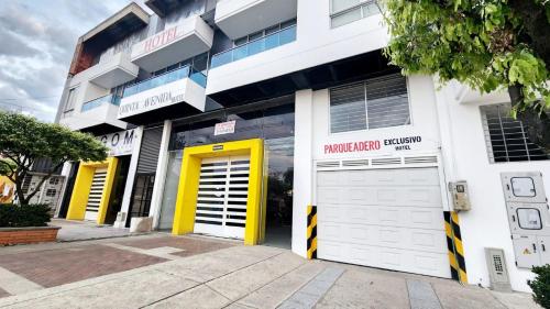 a building with two garage doors and a yellow door at Hotel Quinta Avenida in Yopal