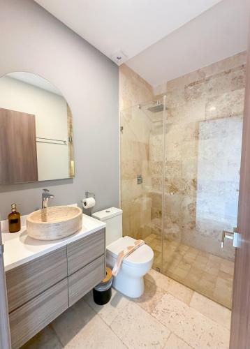 a bathroom with a sink and a toilet and a shower at Stay Near The Sea HOTEL ZONE TULUM 1 Bedroom in Tulum