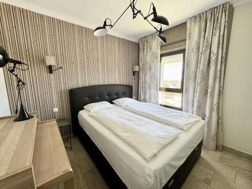 a bedroom with a bed and a desk and a window at Luxury 2 Bedrooms Ocean View Iguazu in Playa del Ingles