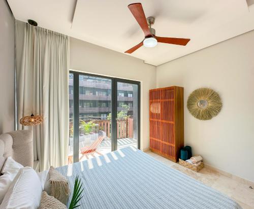 a bedroom with a bed and a ceiling fan at Stay Near The Sea HOTEL ZONE TULUM 1 Bedroom in Tulum